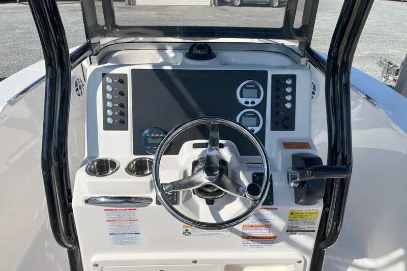 Slide: The Image of 2026 Robalo R202 Explorer boat dashboard with steering wheel and control panel. - 5