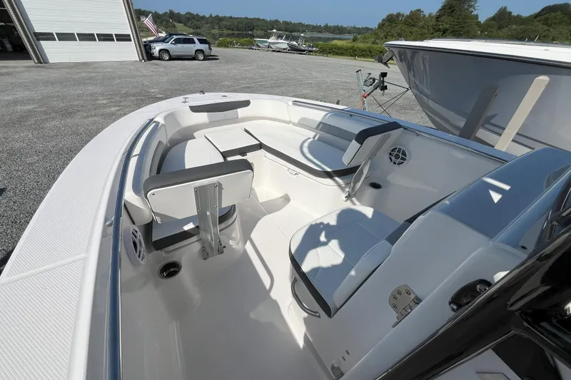 Slide: The Image of 2026 Robalo R202 Explorer boat interior with seating and storage, parked outdoors. - 6