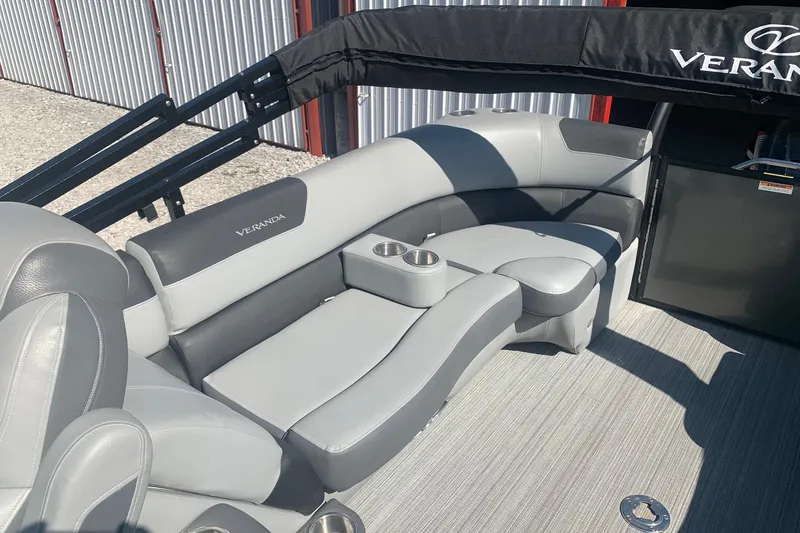 Slide: The Image of 2020 Veranda Relax VR22RC boat interior with gray seating and cup holders. - 11