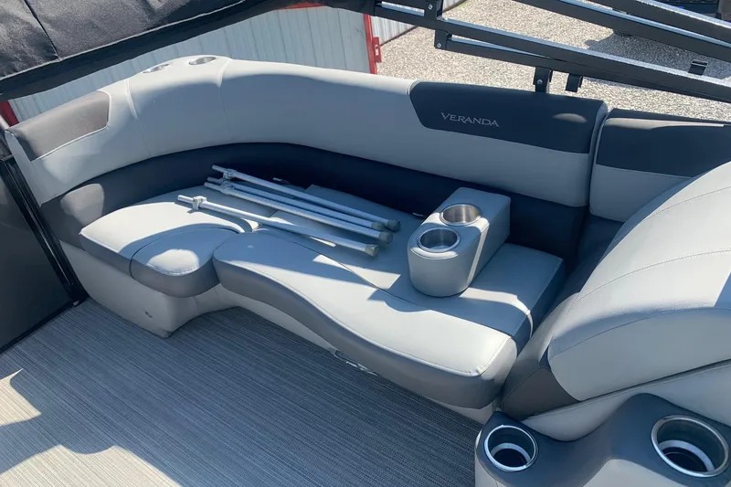 Slide: The Image of 2020 Veranda Relax VR22RC boat interior with gray seating and cup holders. - 12