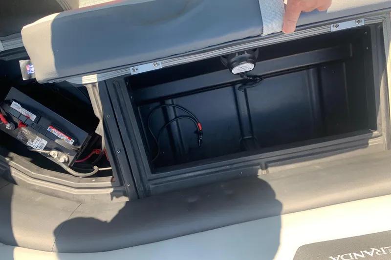 Slide: The Image of Open storage compartment in 2020 Veranda Relax VR22RC boat, showing battery and wiring. - 16