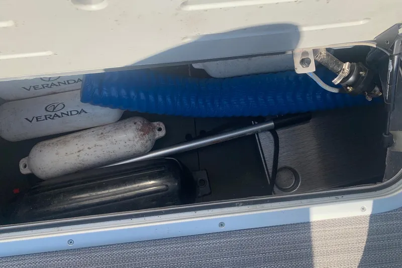 Slide: The Image of Storage compartment of 2020 Veranda Relax VR22RC with boat fenders and hose. - 24