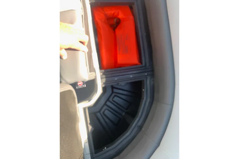 Slide: The Image of 2020 Veranda Relax VR22RC boat storage compartment with orange life jacket inside. - 25