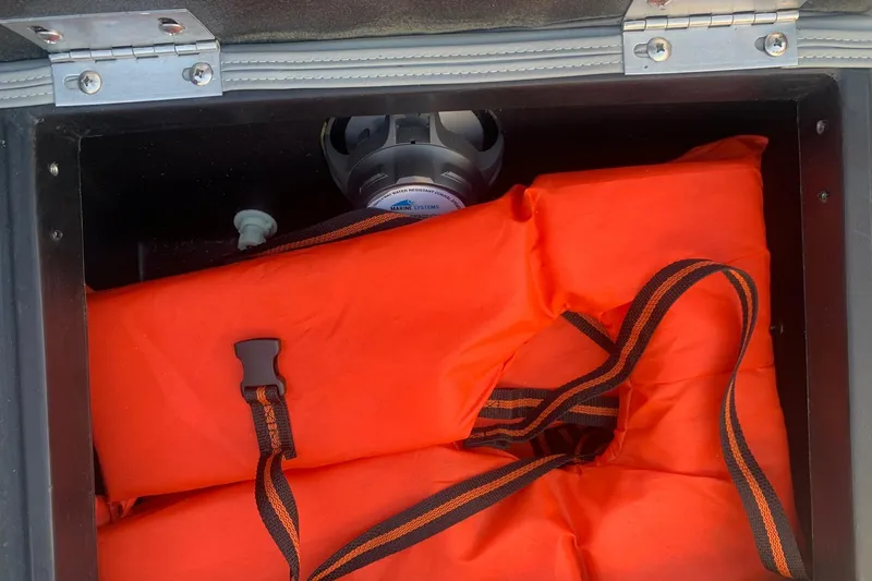 Slide: The Image of Storage compartment with orange life jackets in a 2020 Veranda Relax VR22RC boat. - 27