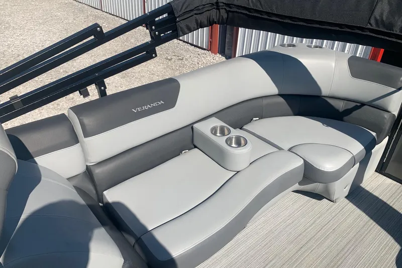 Slide: The Image of 2020 Veranda Relax VR22RC boat interior with gray seating and cup holders. - 28