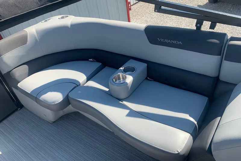 Slide: The Image of 2020 Veranda Relax VR22RC boat seating with cup holders, featuring sleek gray upholstery. - 29
