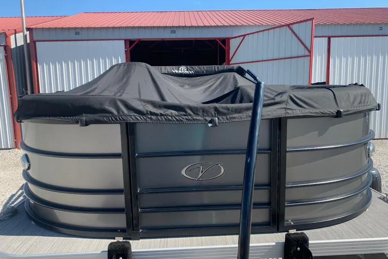Slide: The Image of 2020 Veranda Relax VR22RC pontoon boat with cover, parked near storage units. - 3