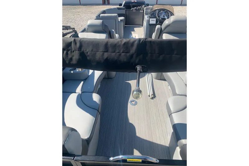 Slide: The Image of 2020 Veranda Relax VR22RC pontoon boat interior with gray seating and steering console. - 30