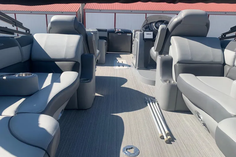 Slide: The Image of 2020 Veranda Relax VR22RC pontoon boat interior with gray seating and steering console. - 31