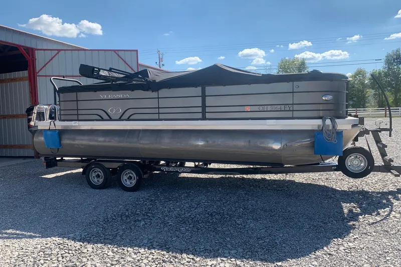 Slide: The Image of 2020 Veranda Relax VR22RC pontoon boat on trailer, parked outside a barn. - 4