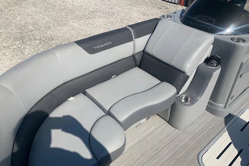 Slide: The Image of 2020 Veranda Relax VR22RC boat interior with gray seating and cup holders. - 7