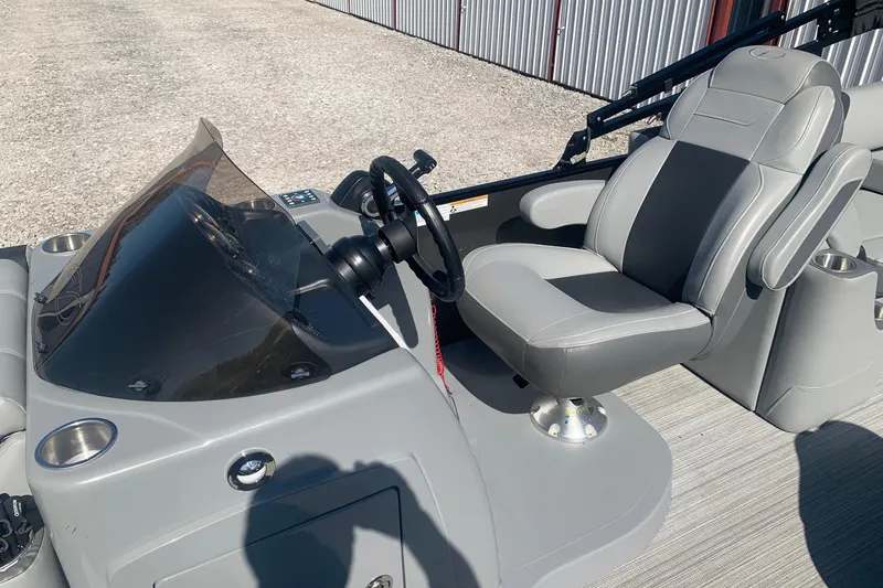 Slide: The Image of 2020 Veranda Relax VR22RC boat interior with steering wheel and captain's chair. - 9