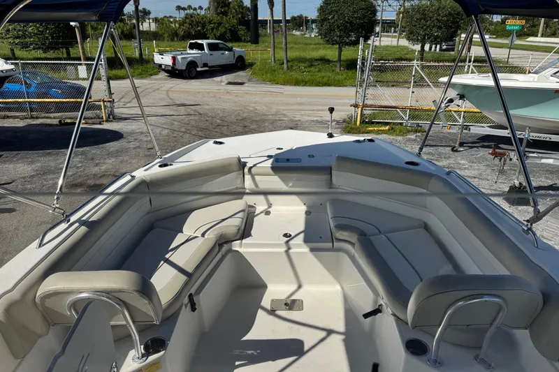 Slide: The Image of 2015 NauticStar 231 Angler boat interior with seating and canopy. - 12