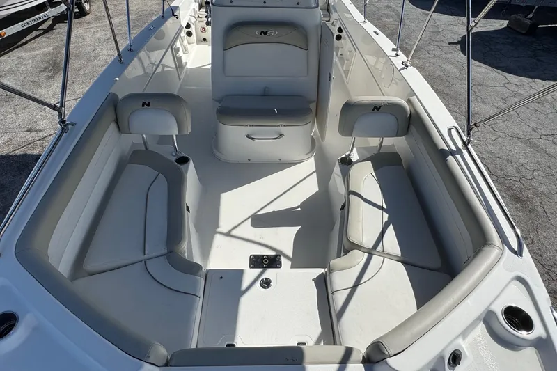 Slide: The Image of 2015 NauticStar 231 Angler boat interior with seating and storage compartments. - 13