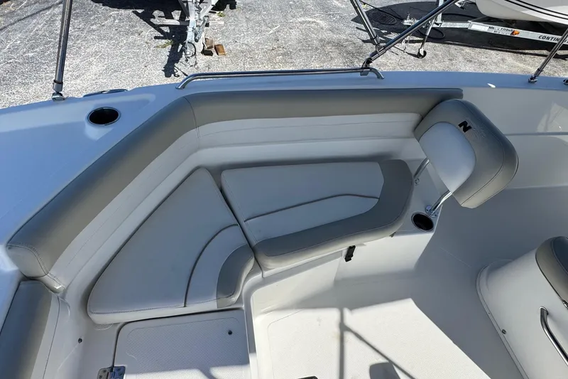 Slide: The Image of 2015 NauticStar 231 Angler boat interior with gray seating and cup holders. - 19