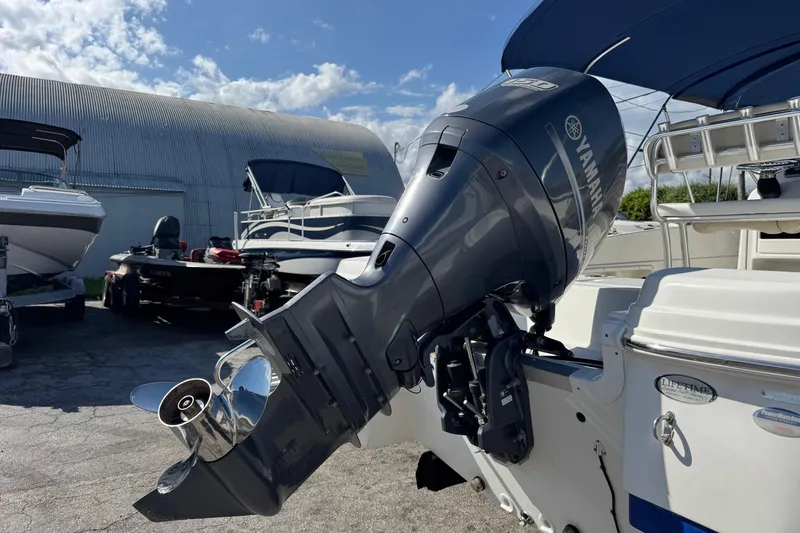 Slide: The Image of 2015 NauticStar 231 Angler boat with Yamaha outboard motor in a marina setting. - 37