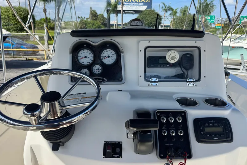 Slide: The Image of 2015 NauticStar 231 Angler boat dashboard with steering wheel and control panel. - 6