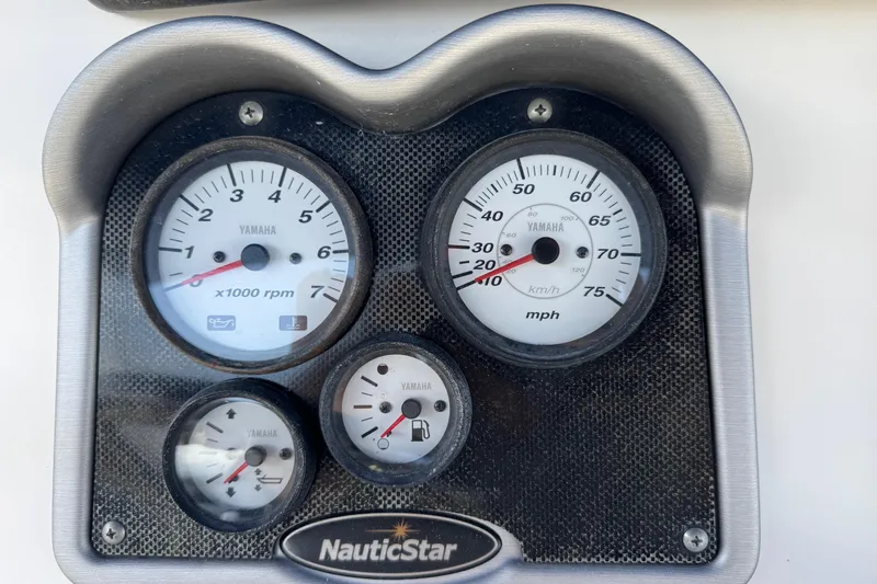 Slide: The Image of Dashboard gauges of a 2015 NauticStar 231 Angler boat, featuring Yamaha instruments. - 7