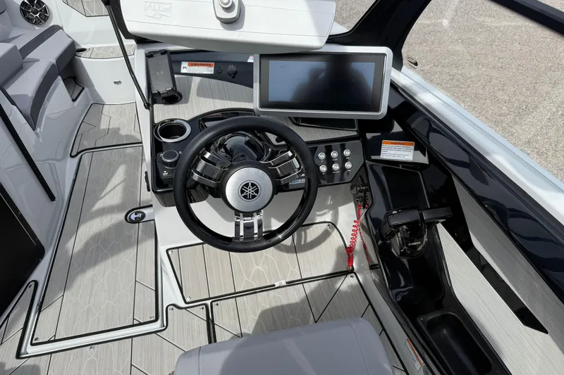 Slide: The Image of 2024 Yamaha Boats 222XD cockpit with steering wheel, touchscreen, and modern controls. - 12