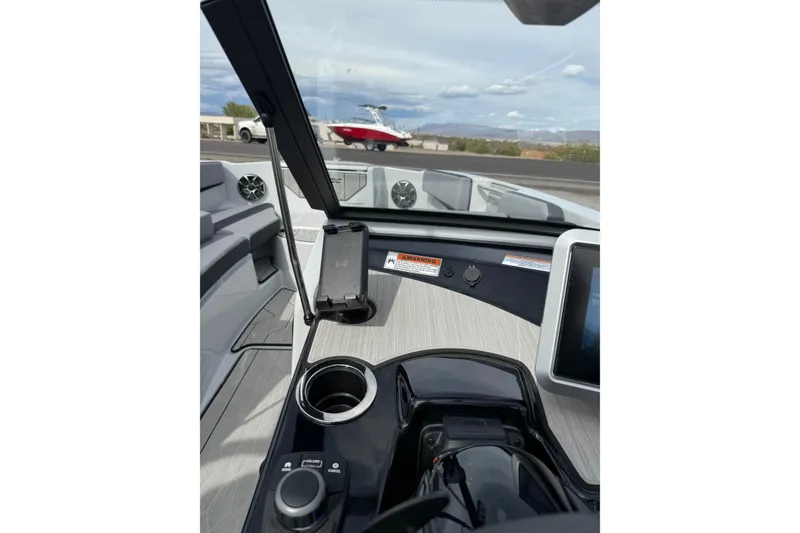 Slide: The Image of 2024 Yamaha Boats 222XD dashboard with modern controls and phone holder. - 17