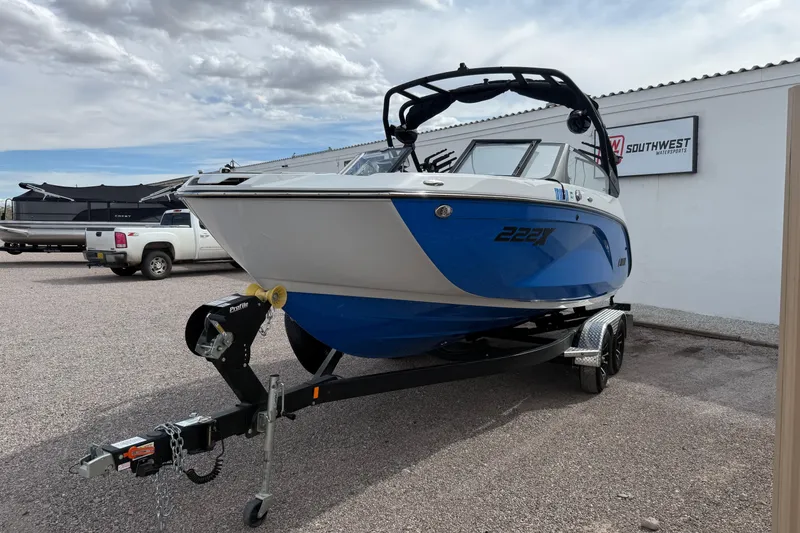 Slide: The Image of 2024 Yamaha Boats 222XD on trailer, displayed outdoors at dealership. - 3