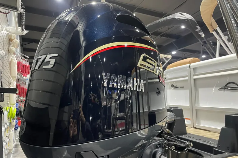 Slide: The Image of Yamaha 175 outboard motor on 2025 SunCatcher Fusion 322RC boat in showroom. - 2