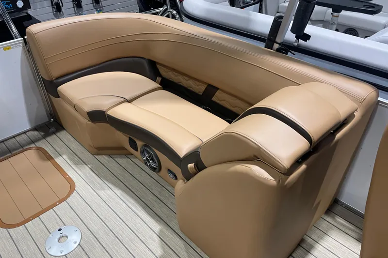 Slide: The Image of Luxurious seating on 2025 SunCatcher Fusion 322RC boat, featuring tan upholstery and integrated speakers. - 7