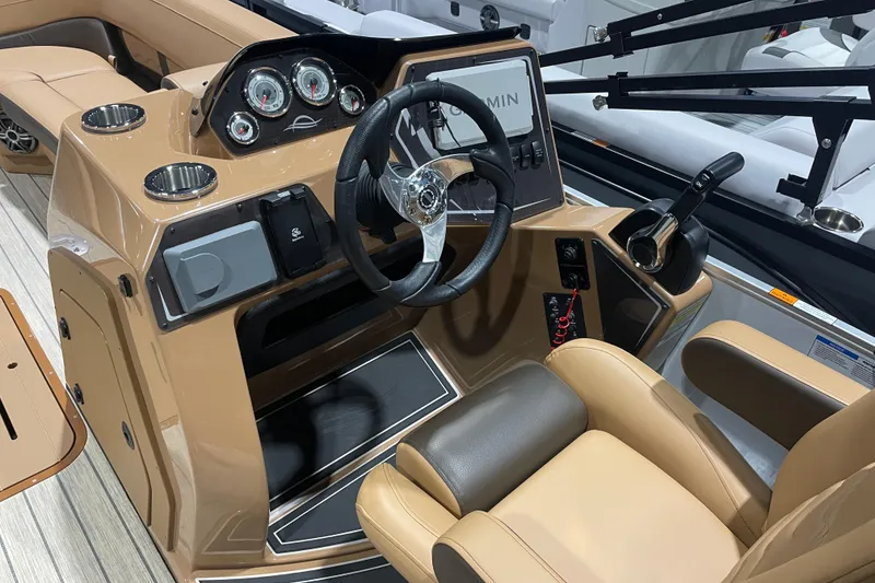 Slide: The Image of 2025 SunCatcher Fusion 322RC boat cockpit with modern steering and controls. - 8