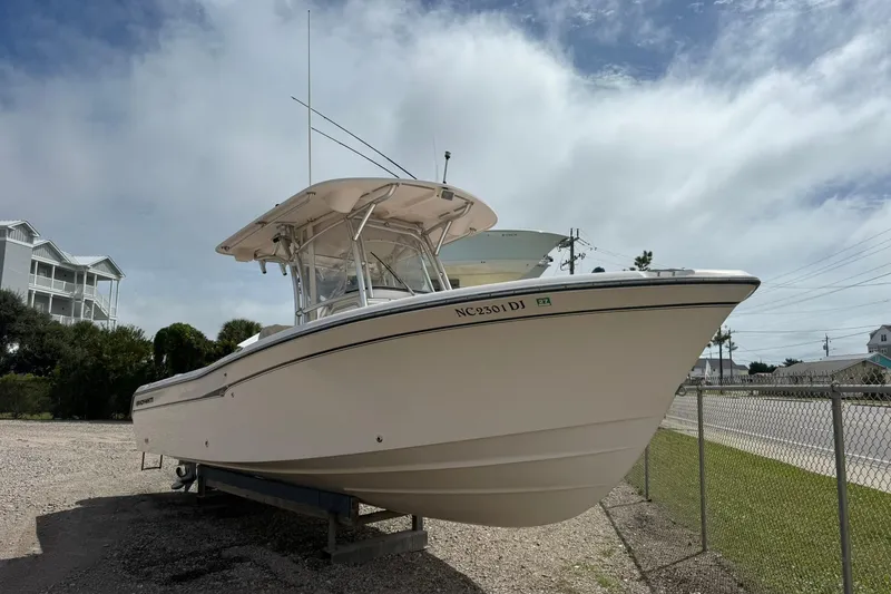 The Image of 2008 Grady-White Release 283 boat on trailer, parked outdoors under cloudy sky. - 0