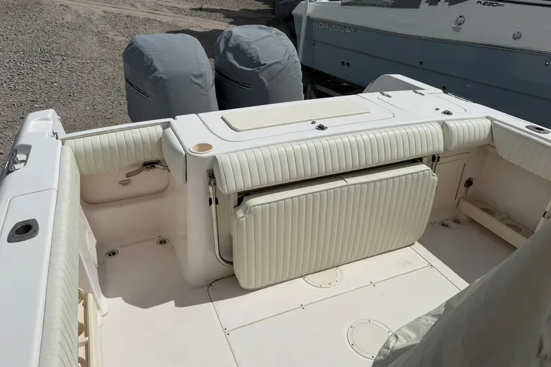 Slide: The Image of 2008 Grady-White Release 283 boat interior with cushioned seating and covered engines. - 10
