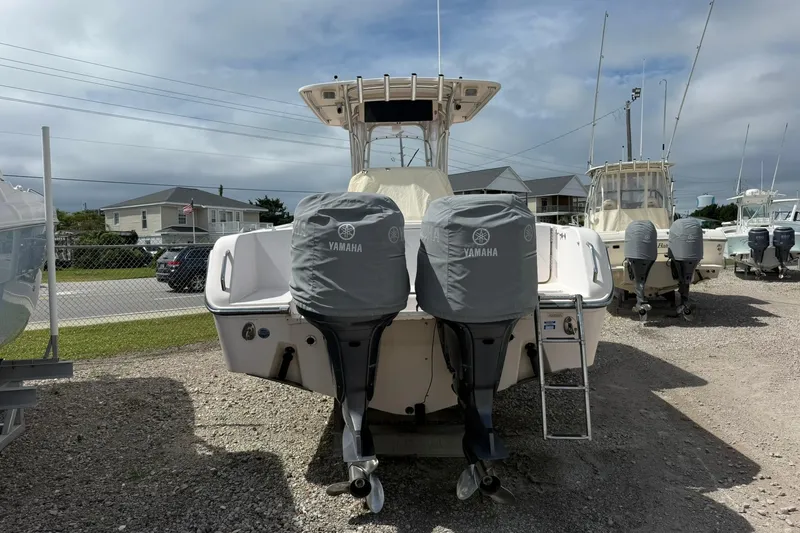 Slide: The Image of 2008 Grady-White Release 283 boat with Yamaha engines, parked on gravel lot. - 2