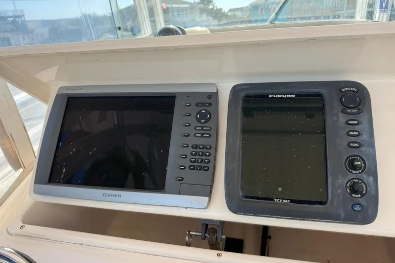 Slide: The Image of 2008 Grady-White Release 283 boat dashboard with Garmin and Furuno navigation systems. - 4