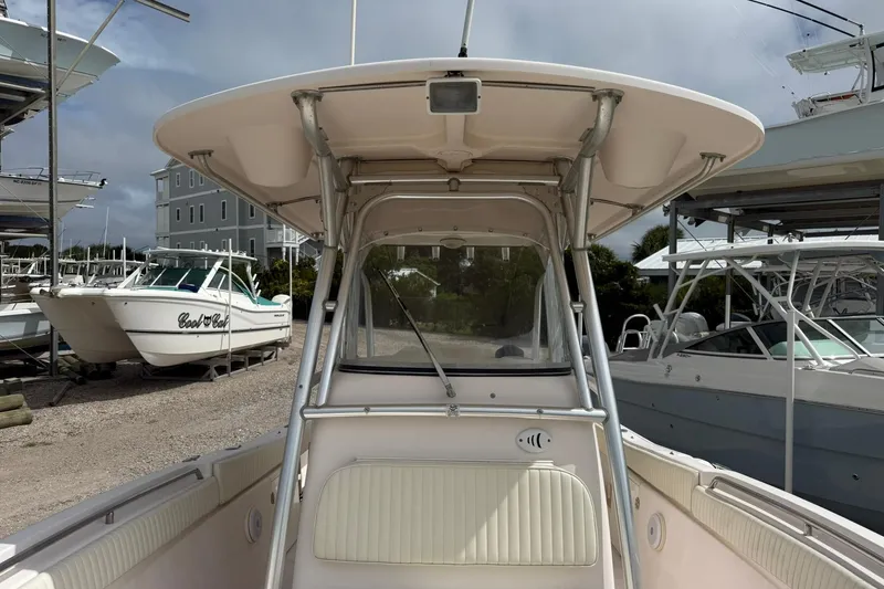 Slide: The Image of 2008 Grady-White Release 283 boat docked, surrounded by other boats under cloudy sky. - 7