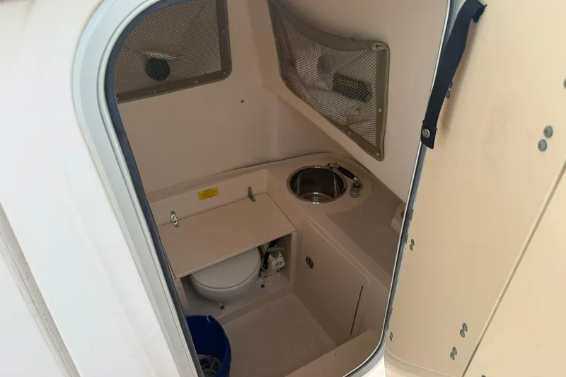 Slide: The Image of 2008 Grady-White Release 283 boat interior with compact bathroom and sink. - 9