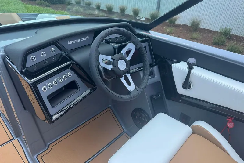 Slide: The Image of 2025 MasterCraft NXT24 boat interior with modern steering wheel and control panel. - 7