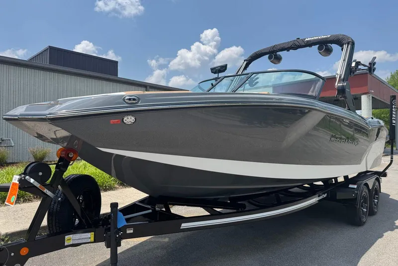 Slide: The Image of 2025 MasterCraft NXT24 boat on trailer, sleek design, sunny day background. - 8