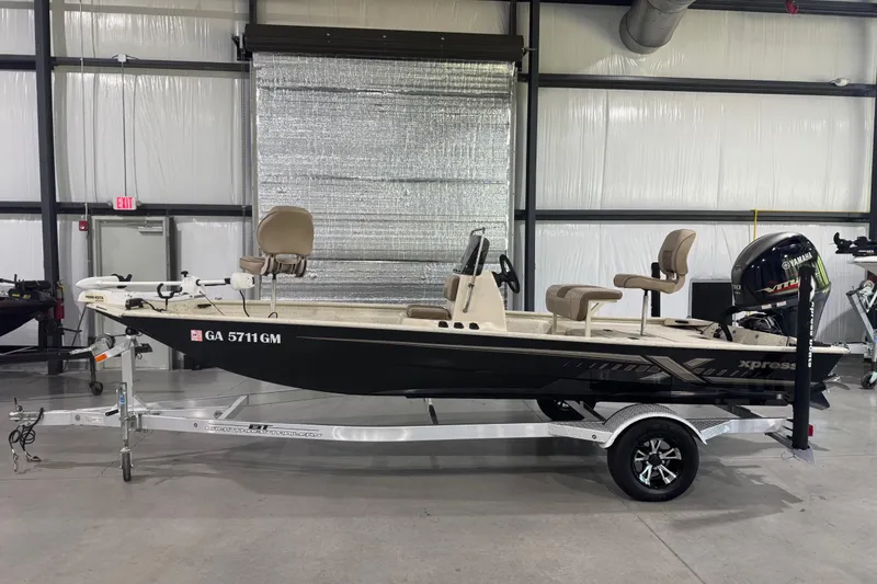The Image of 2020 Xpress X18B boat on trailer in indoor storage facility. - 1