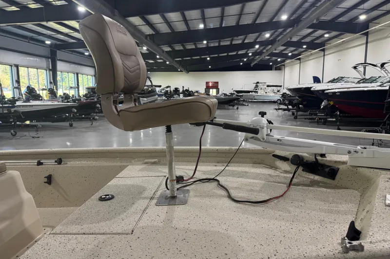 Slide: The Image of 2020 Xpress X18B boat interior with swivel seat and trolling motor in showroom. - 11