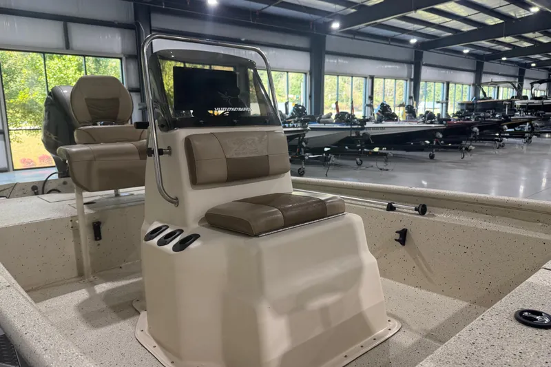 Slide: The Image of 2020 Xpress X18B boat interior with seating and console in showroom. - 12