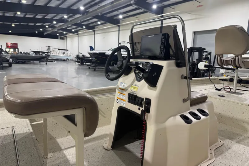 Slide: The Image of 2020 Xpress X18B boat interior with steering console in a showroom. - 13