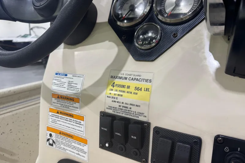 Slide: The Image of Control panel of 2020 Xpress X18B boat with capacity and warning labels. - 3