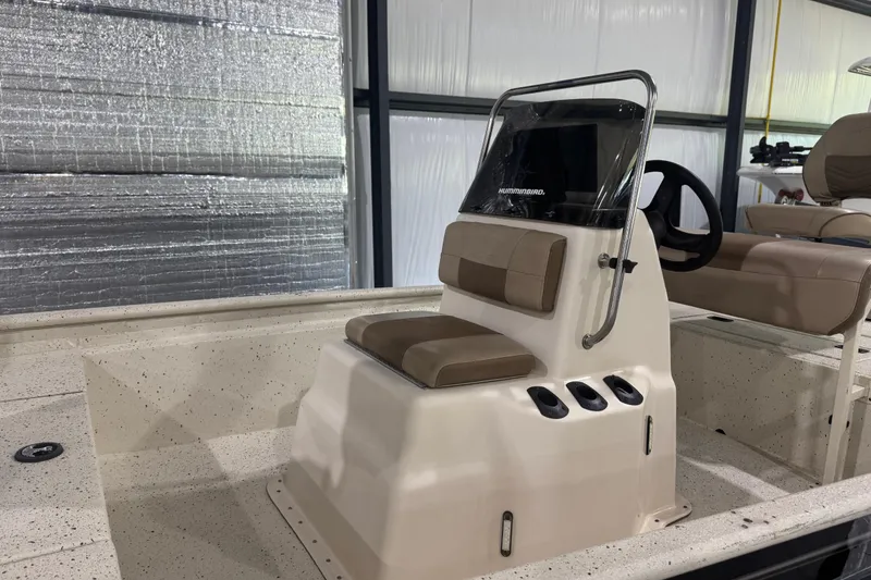 Slide: The Image of 2020 Xpress X18B boat interior with steering console and seating in a showroom. - 6