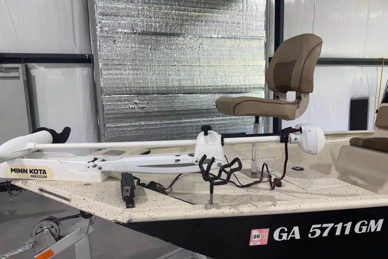 Slide: The Image of 2020 Xpress X18B boat with Minn Kota Maxxum trolling motor and seating, in a storage facility. - 7