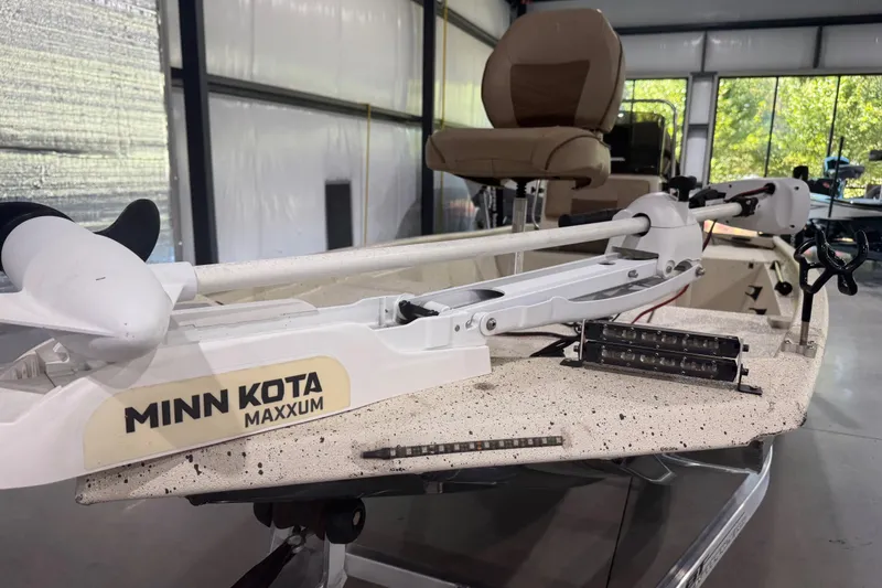 Slide: The Image of Minn Kota Maxxum trolling motor on 2020 Xpress X18B boat in a garage setting. - 9