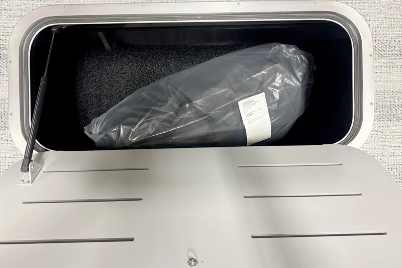 Slide: The Image of Storage compartment of 2026 Bennington 22SSB boat with packaged item inside. - 10