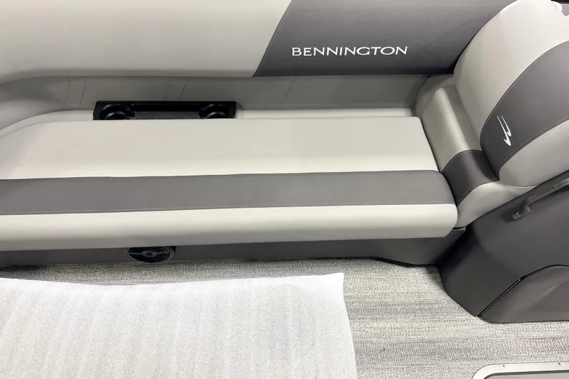 Slide: The Image of 2026 Bennington 22SSB boat interior with gray seating and logo detail. - 3