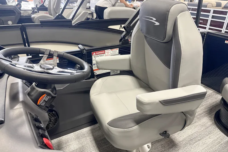 Slide: The Image of 2026 Bennington 22SSB boat interior with steering wheel and captain's chair. - 6