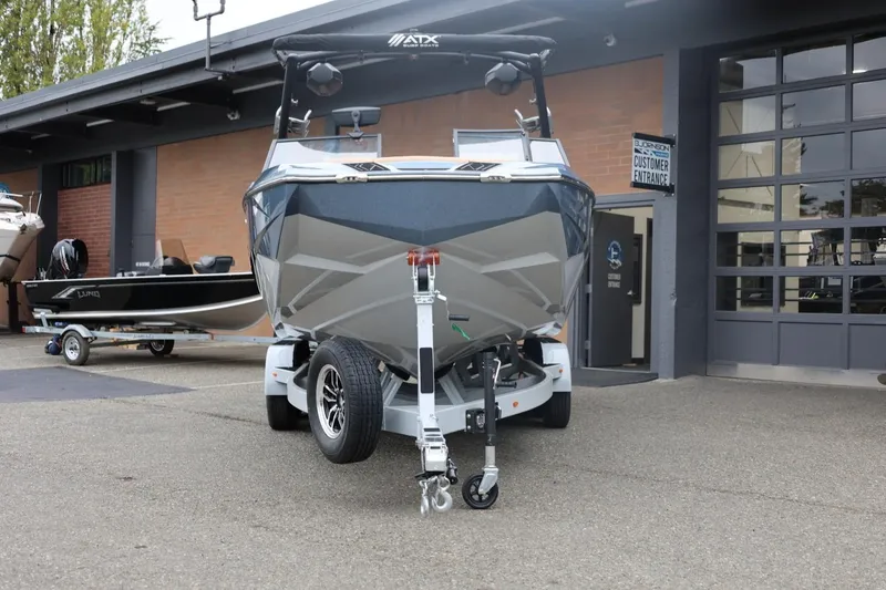 Slide: The Image of 2026 ATX Surf Boats 22 Type-S on trailer outside dealership. - 10