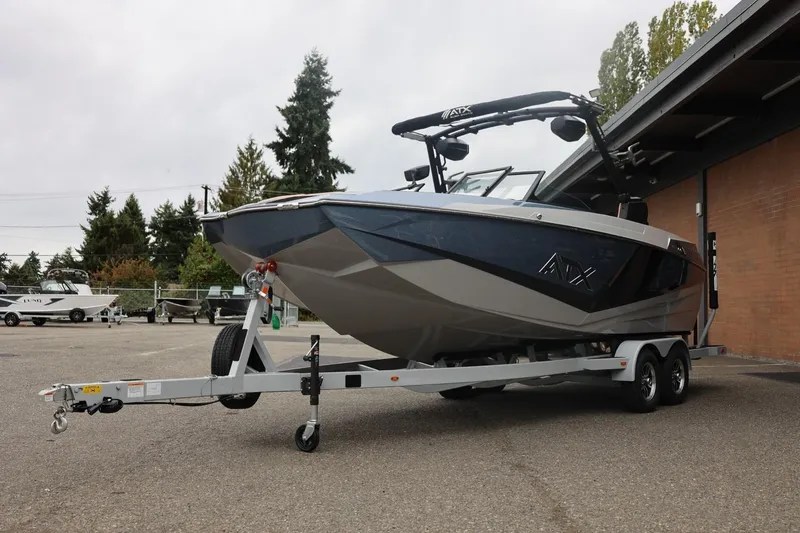 Slide: The Image of 2026 ATX Surf Boats 22 Type-S on trailer, parked outdoors near building. - 12