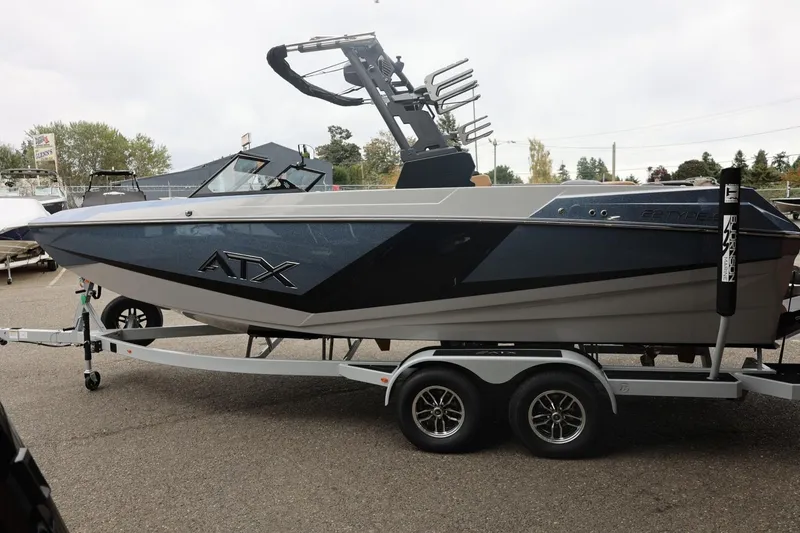 Slide: The Image of 2026 ATX Surf Boats 22 Type-S on trailer, sleek design, parked outdoors. - 13